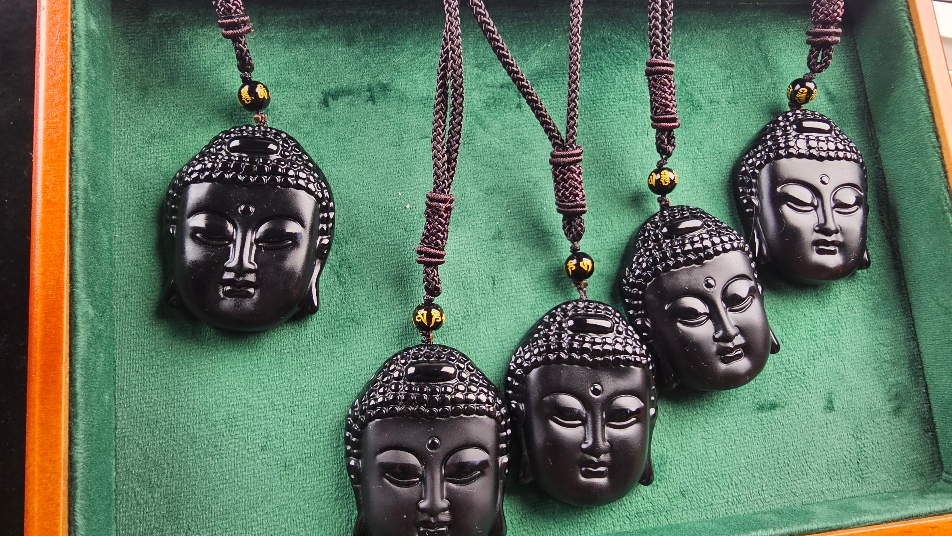 Obsidian Buddha Head Pendant Hand-carved crystal necklace symbolizing peace, mindfulness and protection.